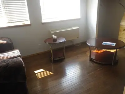a living room with two tables and a couch at Alcan Motor Inn in Haines Junction