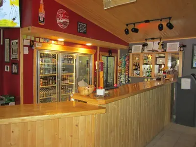 a bar in a restaurant with a counter at Alcan Motor Inn in Haines Junction