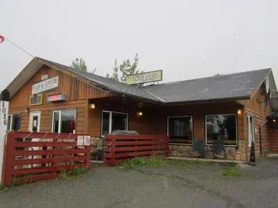 a wooden building with a sign that reads disco at Alcan Motor Inn in Haines Junction