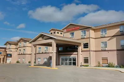 a rendering of a hotel with a parking lot at Stonebridge Hotel Dawson Creek in Dawson Creek