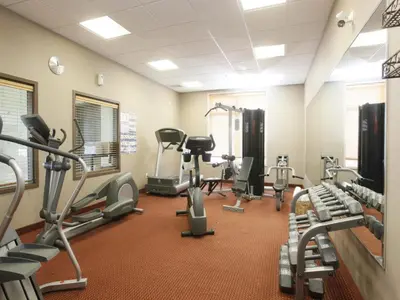 a fitness room with treadmills and cardio machines at Stonebridge Hotel Dawson Creek in Dawson Creek