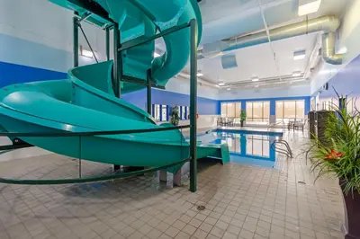 a slide in a pool room with a swimming pool at Best Western High Road Inn in Edson