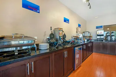a kitchen with wooden cabinets and a counter top at Best Western Northgate in Nanaimo