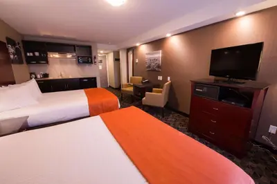 a hotel room with two beds and a flat screen tv at Best Western Northgate in Nanaimo