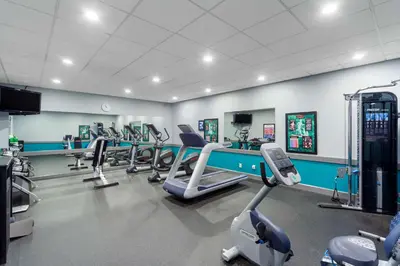 a gym with a row of treadms and cardio machines at Best Western PLUS City Centre Inn in Edmonton