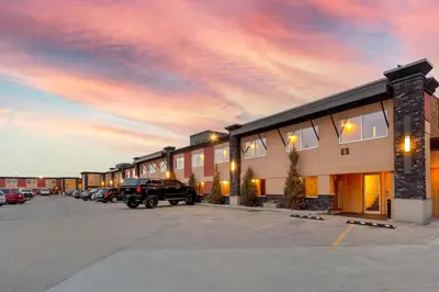a building with a truck parked in a parking lot at Best Western PLUS City Centre Inn in Edmonton