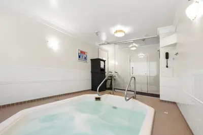 a bath tub in a room with white walls at Best Western Plus Columbia River Hotel in Trail