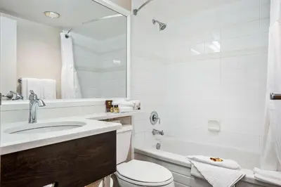 a bathroom with a sink and a toilet and a tub at Best Western Plus Columbia River Hotel in Trail