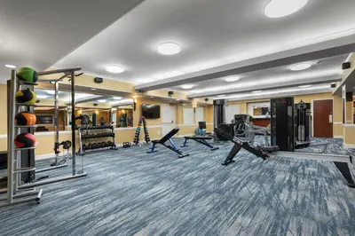 a gym with treadmills and machines in a room at Best Western Plus Columbia River Hotel in Trail