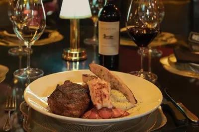 a plate of food on a table with wine glasses at Best Western Plus Columbia River Hotel in Trail