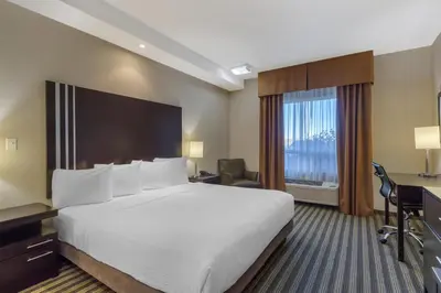 a hotel room with a large bed and a desk at Best Western Plus Sherwood Park in Sherwood Park