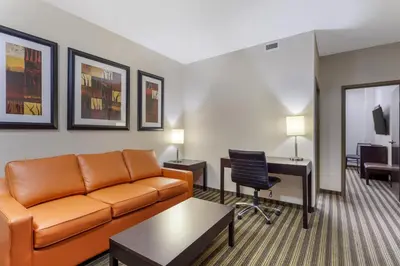 a living room with a couch and a desk at Best Western Plus Sherwood Park in Sherwood Park