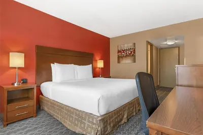 a hotel room with a large bed and a desk at Best Western Terrace Inn in Terrace