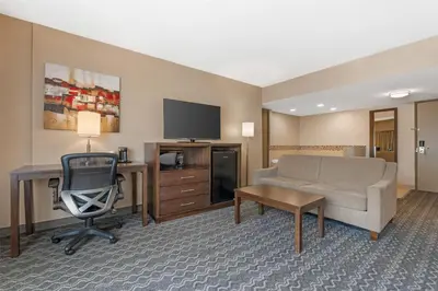 a hotel room with a couch and a desk and a tv at Best Western Terrace Inn in Terrace
