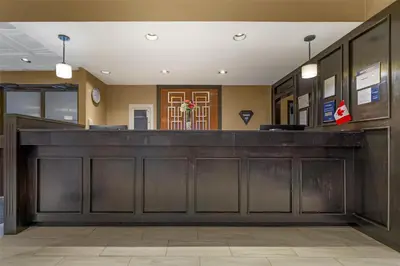 a lobby with a large wooden bar in a building at Best Western Terrace Inn in Terrace
