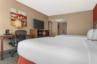 a hotel room with two beds and a desk and a tv at Best Western Terrace Inn in Terrace