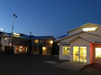 a group of buildings in a parking lot at night at Cache Creek Inn in Cache Creek