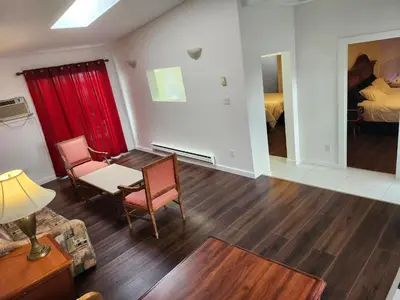 a living room with a table and chairs and a bed at Cache Creek Inn in Cache Creek