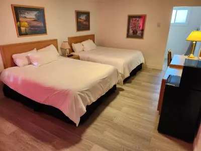 a hotel room with two beds in a room at Cache Creek Inn in Cache Creek