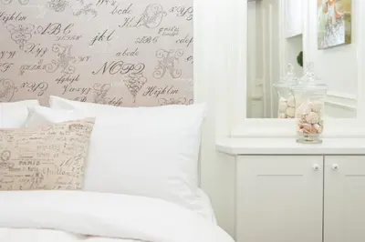 a bedroom with a bed and a wall with writing on it at The Craigmyle Inn in Victoria