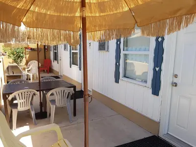a patio with a table and chairs and an umbrella at Creston Valley Motel in Creston