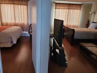 a room with a television and a bedroom with a bed at Croft Inn Motel in Crofton