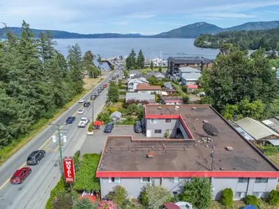 an aerial view of a town with a street and a lake at Croft Inn Motel in Crofton
