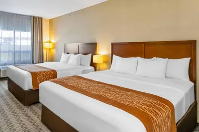 a hotel room with two beds and a window at Comfort Inn in Dawson Creek