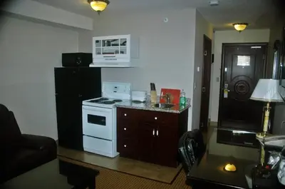 a kitchen with a white stove and a black refrigerator at Days Inn by Wyndham Athabasca in Athabasca