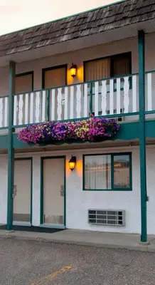 a building with a balcony with flowers on it at Grama's Inn in Prince George