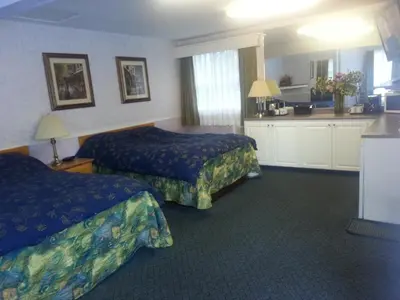 a hotel room with two beds and a kitchen at Heritage Inn in Hope