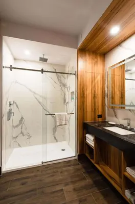 a bathroom with a glass shower and a sink at Hyatt Regency Calgary in Calgary