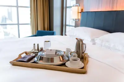a tray with a tea set on a bed at Hyatt Regency Calgary in Calgary