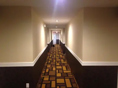 a hallway with a long corridor with a long hallway at Days Inn by Wyndham Sylvan Lake in Sylvan Lake