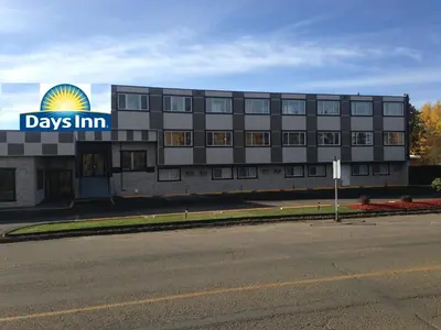 a building with a days inn sign in front of it at Days Inn by Wyndham Sylvan Lake in Sylvan Lake