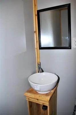 a bathroom with a white sink and a mirror at Jasper Way Inn Resort & Campground in Clearwater