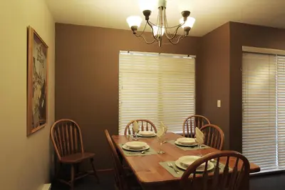 a dining room with a wooden table and chairs at Sunpath Condos by Whistler Retreats in Whistler