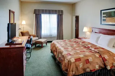 a hotel room with a bed and a desk at Lakeview Inns & Suites - Slave Lake in Slave Lake