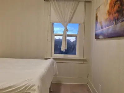 a bedroom with a bed and a window at John's House in Vancouver West in Vancouver