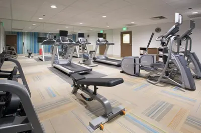 a gym with several treadmills and cardio machines at Holiday Inn Express & Suites - North Battleford by IHG in North Battleford