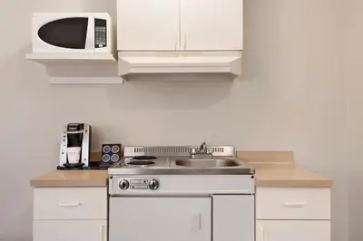 a kitchen with a sink and a microwave at Travelodge by Wyndham McBride in McBride