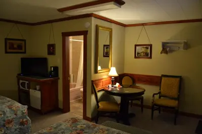 a hotel room with a bed and a table and chairs at North Star Motel in Kimberley