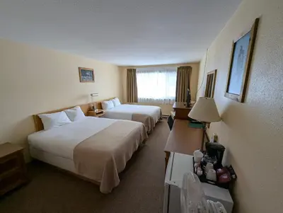 a hotel room with two beds and a window at Northway Motor Inn in Dease Lake