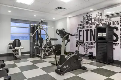 a gym with treadmills and ellipticals in a room at Executive Residency by Best Western Calgary City View North in Calgary