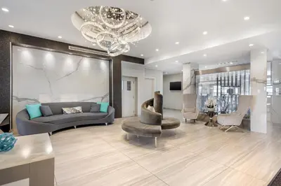 a living room with a couch and chairs and a chandelier at Executive Residency by Best Western Calgary City View North in Calgary