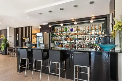 a bar in a restaurant with black bar stools at Executive Residency by Best Western Calgary City View North in Calgary