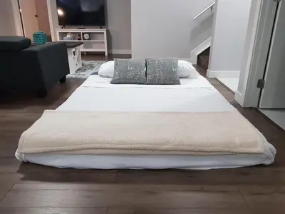 a large bed with two pillows in a room at Modern Executive Suite I Complimentary Netflix & Parking! in Edmonton