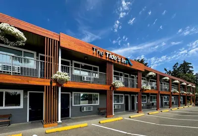 a building with a sign that reads the tides inn at The Tide's Inn in Parksville