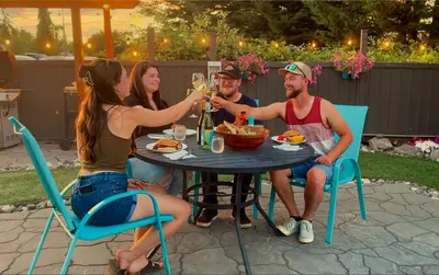 a group of people sitting around a table drinking champagne at The Tide's Inn in Parksville