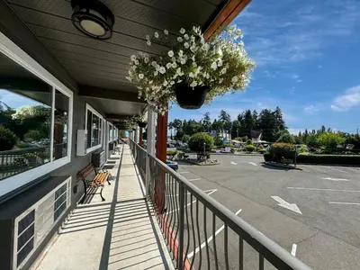 a balcony with a hanging basket of flowers on a building at The Tide's Inn in Parksville